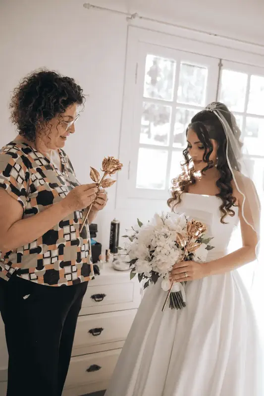 Mother handing a gold dipped rose to the bride, a gift presented in a satin box or on a crocodile leather base